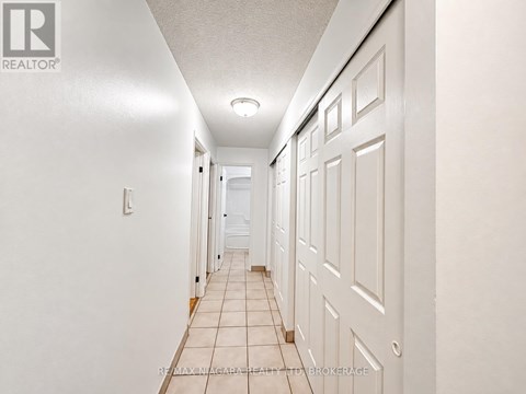A room with a window and wooden flooring.