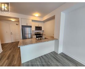 A kitchen with a stainless steel refrigerator, microwave, and oven.