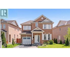 A large brick house with a garage is for sale.