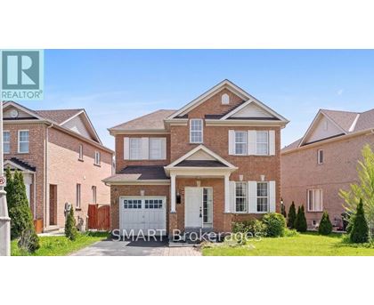 A large brick house with a garage is for sale.