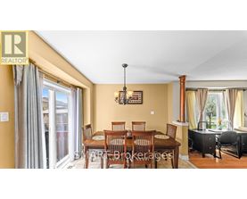A dining room with a table set for six.