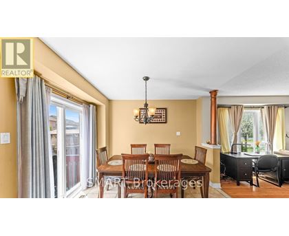 A dining room with a table set for six.