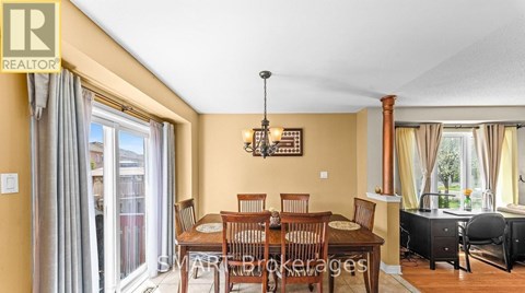 A dining room with a table set for six.