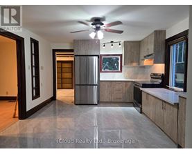 A modern kitchen with a refrigerator, stove, and oven.
