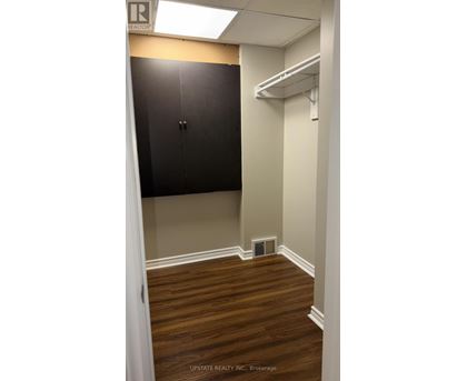 A small room with a cabinet and a shelf.
