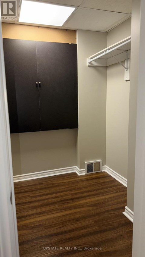 A small room with a cabinet and a shelf.