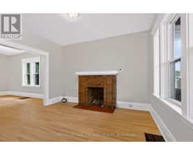 A room with a fireplace and wooden floors.