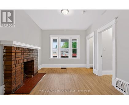 A room with a fireplace and a window.