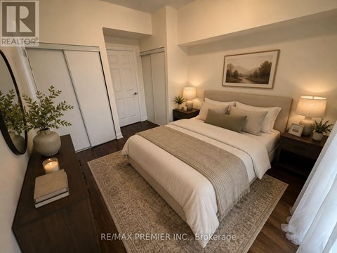 A bedroom with a large bed, a nightstand with a lamp, and a painting on the wall.