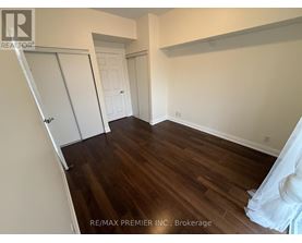 A room with wood flooring and a white door.