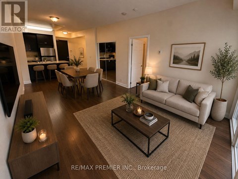 A living room with a couch, coffee table, and dining table.