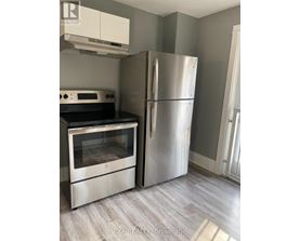 A kitchen with a stainless steel refrigerator and oven.