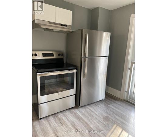 A kitchen with a stainless steel refrigerator and oven.