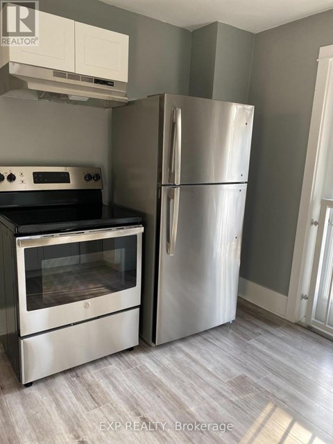 A kitchen with a stainless steel refrigerator and oven.