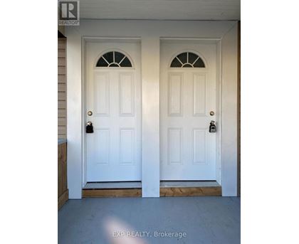 A white double door with a glass window in the middle.