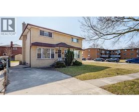 A two-story house with a brown roof and a white window is for sale.