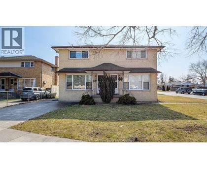 A house with a "REALTOR" sign in front.