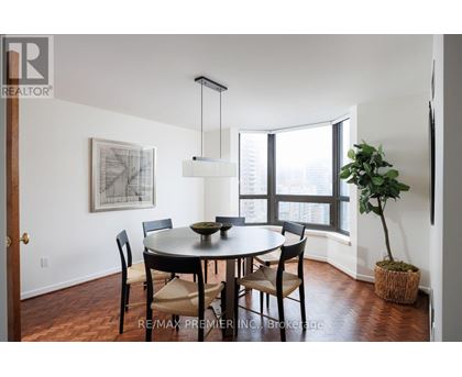 A dining room with a table and chairs.