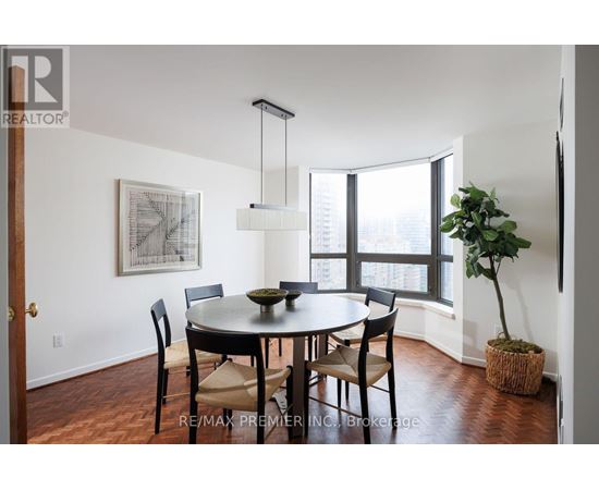A dining room with a table and chairs.