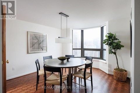 A dining room with a table and chairs.