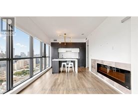 A modern living room with a fireplace and a dining table.