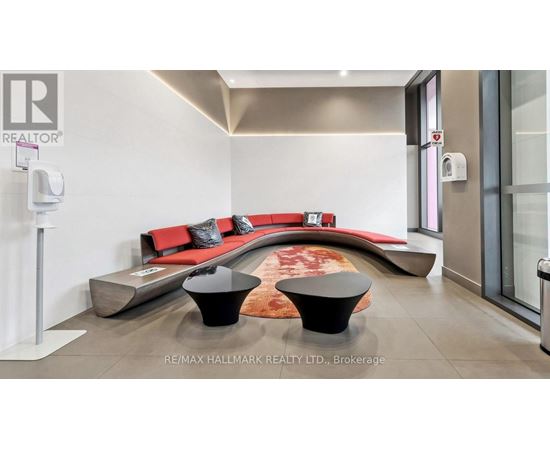A modern living room with a red couch and a black coffee table.