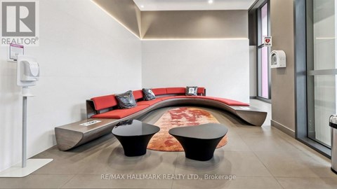 A modern living room with a red couch and a black coffee table.