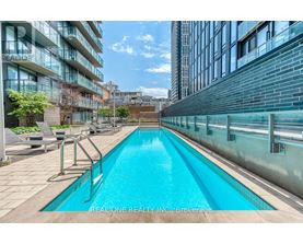 A swimming pool in a courtyard surrounded by buildings.