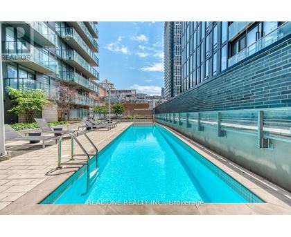 A swimming pool in a courtyard surrounded by buildings.