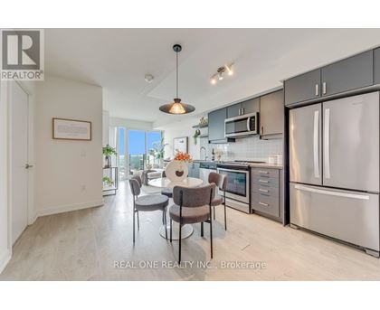 A modern kitchen with a dining table set up.