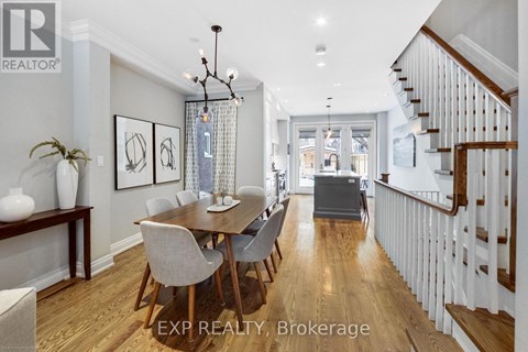 A dining room with a wooden table and chairs.
