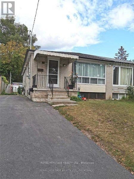A house with a white door and a balcony is for sale.