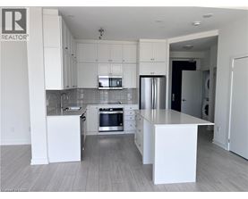 A modern kitchen with white cabinets and a central island.