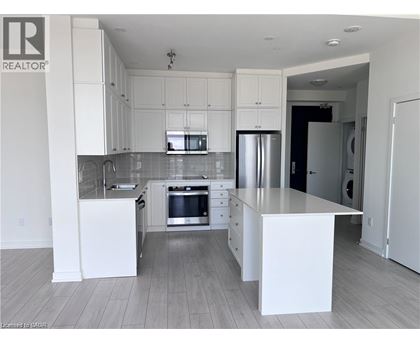 A modern kitchen with white cabinets and a central island.