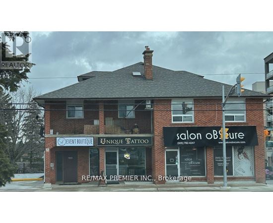 A building with a salon and tattoo parlor on the ground floor.