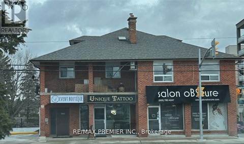 A building with a salon and tattoo parlor on the ground floor.