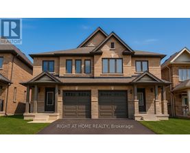 A large, well-maintained house with a brick facade and a large front yard.