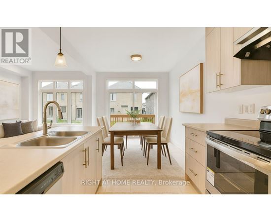 A modern kitchen with a dining table and chairs in the middle.