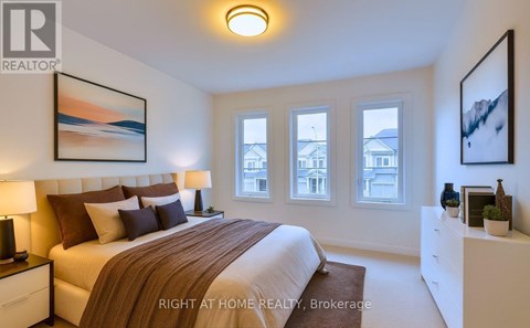 A bedroom with a large bed and a painting on the wall.
