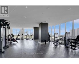 A gym with a view of the city outside the windows.
