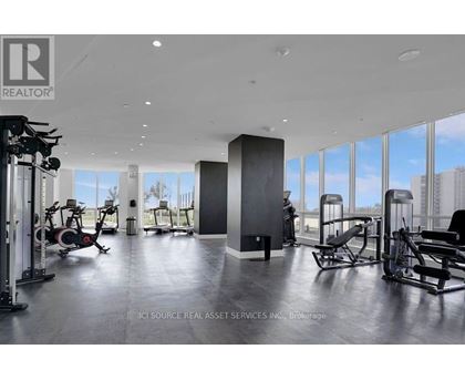 A gym with a view of the city outside the windows.