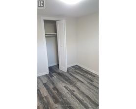 A room with a wooden floor and a white door.