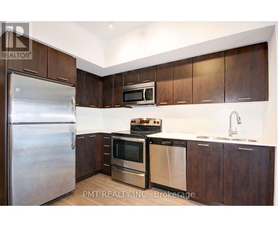 A kitchen with a stainless steel refrigerator, microwave, oven, and sink.