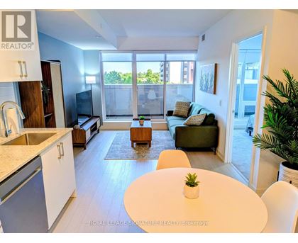 A modern kitchen with a dining table and chairs.