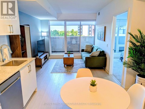 A modern kitchen with a dining table and chairs.