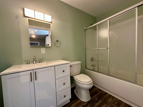 A bathroom with a white sink and toilet.