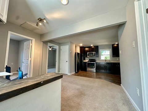 A kitchen with a counter top and a dining area.