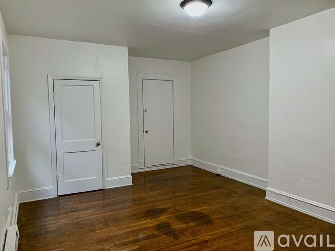A room with two doors and a wooden floor.