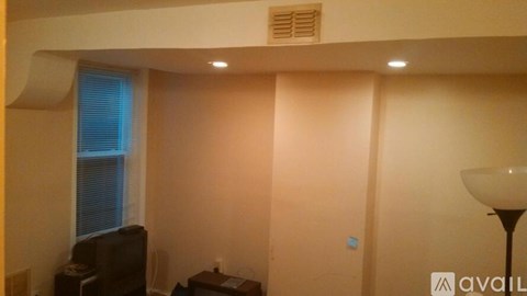 A living room with a television and a lamp.