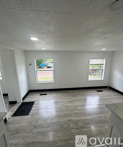 A room with a window and a tiled floor.